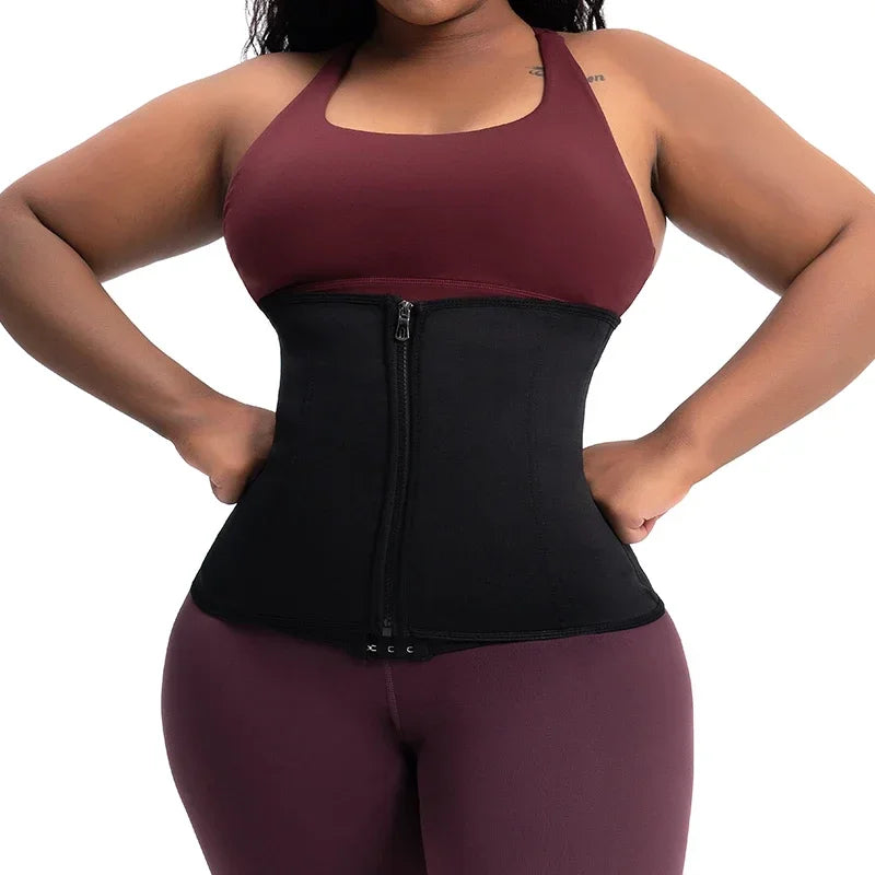 Black body shaping waist trainer worn over activewear – front view showing waist cinching effect – REYVA