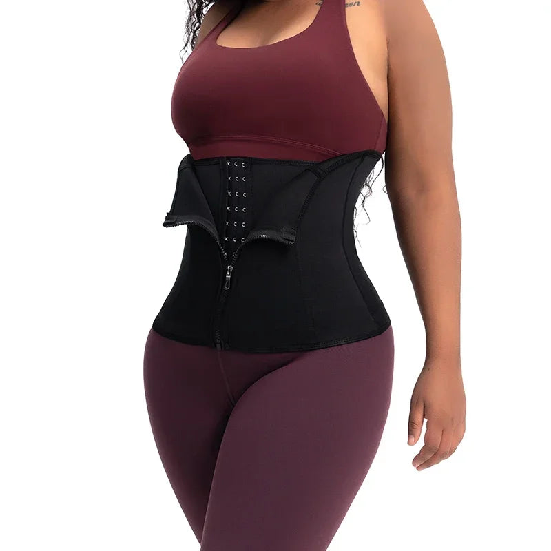 Black body shaping waist trainer worn over activewear – side view showing hook-and-eye and zipper closure – REYVA
